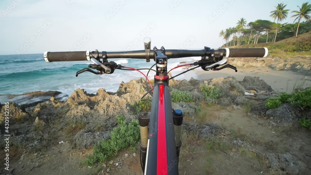 POV of handlebar mountain bike at ocean view. Rocky beach. POV of handlebar mountain bike at ocean view. Rocky beach.