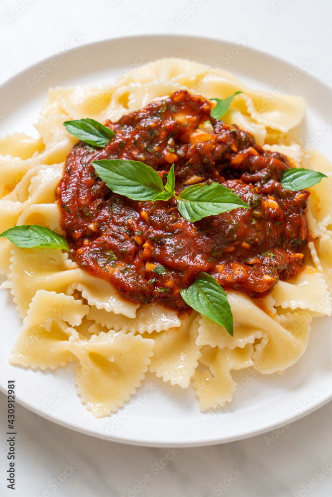farfalle pasta with basil and garlic in tomato sauce farfalle pasta with basil and garlic in tomato sauce