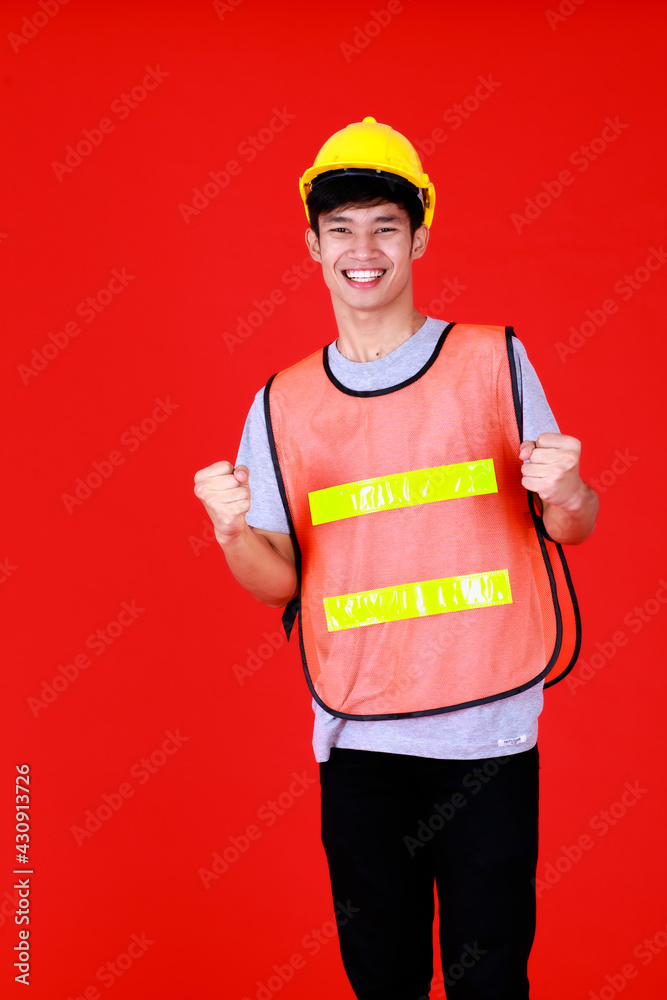 Asian supervisor foreman wearing safety suit and safety helmet standing look at camera with smiling feel happy and confident. Asian supervisor foreman wearing safety suit and safety helmet standing look at camera with smiling feel happy and confident.
