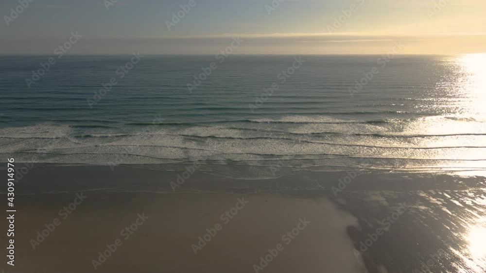Aerial high altitude view of beach and waves at sunset. Drone static Aerial high altitude view of beach and waves at sunset. Drone static