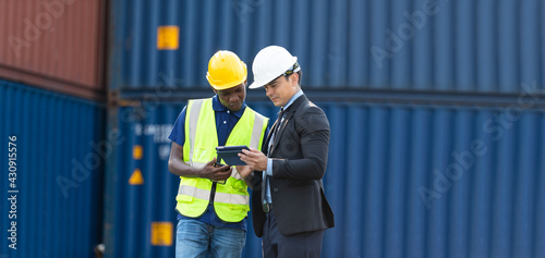 Wallpaper Mural Officer from the Customs Department inspects the cargo in the container yard. Business man in hardhat helmet and African American foreman worker look tablet togetherness Torontodigital.ca