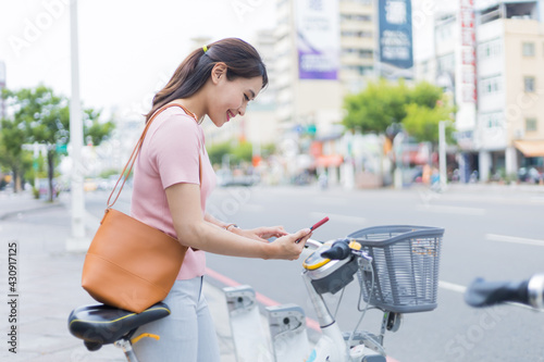 woman rent bicycle from sharing