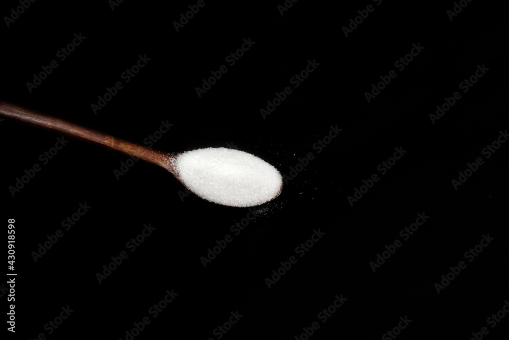 monosodium glutamate, MSG on wooden spoon