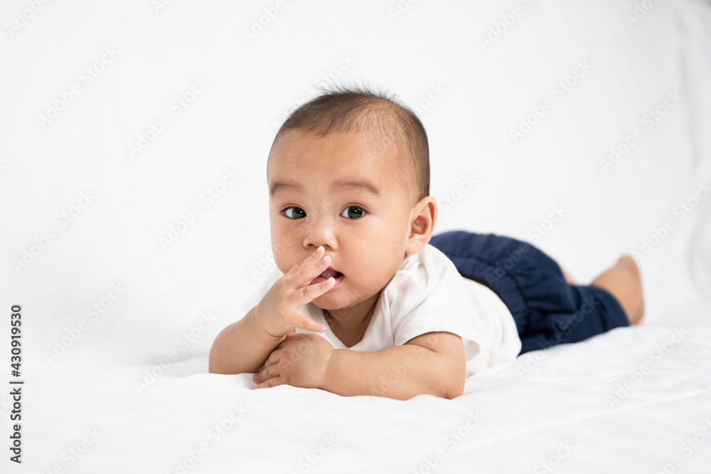 asian cute baby boy on white bed in room asian cute baby boy on white bed in room