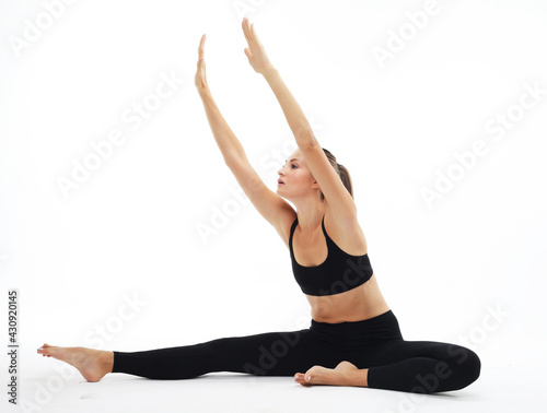 Healthy female isolated on white practicing yoga. A beginner yoga woman is in basic yoga pose.