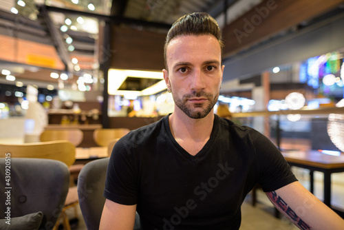 Portrait of handsome man sitting at coffee shop