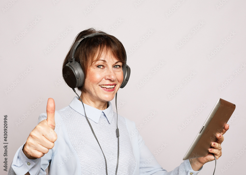Lifestyle, tehnoogy and people concept: An elderly woman gets a new profession using a tablet. Lifestyle, tehnoogy and people concept: An elderly woman gets a new profession using a tablet.