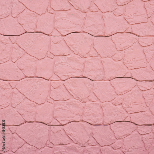 Peach-pink color concrete wall.Urban stylish background.Construction material.Heavy solid wall.Modern design.