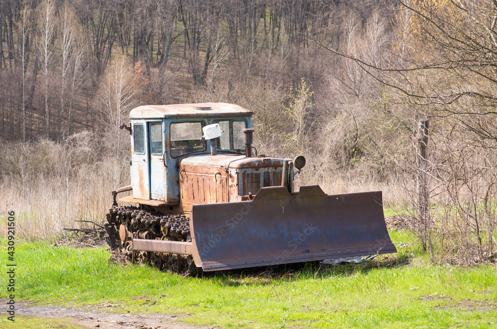 Fototapeta premium old tractor on the grass field