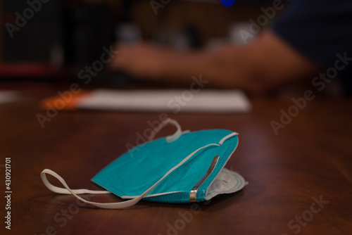 man sitting at desk working on business administration at fire station with mask laying on table wapato washington yakima county photo