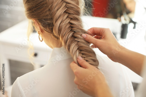 Hairdresser working with cl...