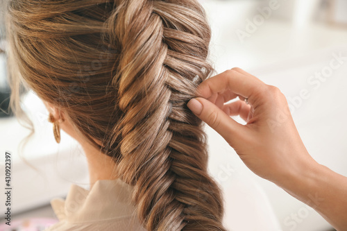 Hairdresser working with client in beauty salon