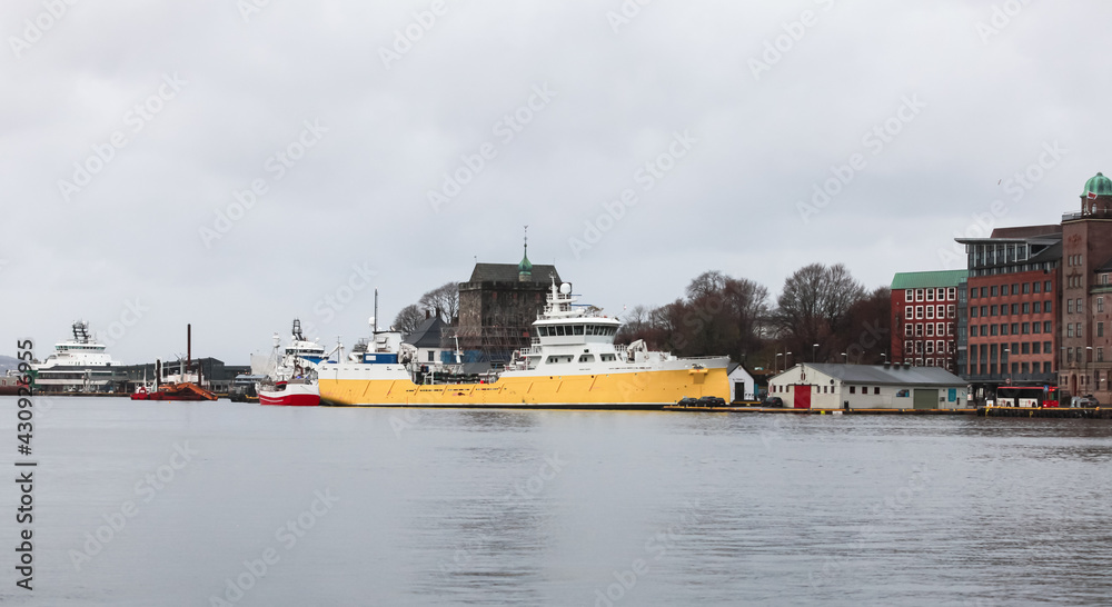 Fish Carrier ship with yellow hull is moored in Bergen