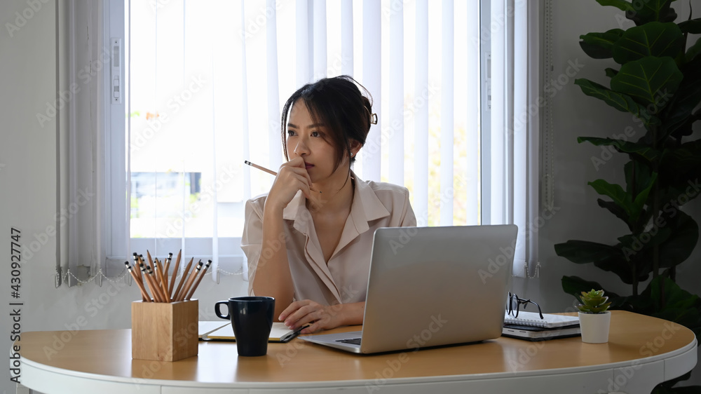 Thoughtful businesswoman looking through the window and thinking solving problem. Thoughtful businesswoman looking through the window and thinking solving problem.