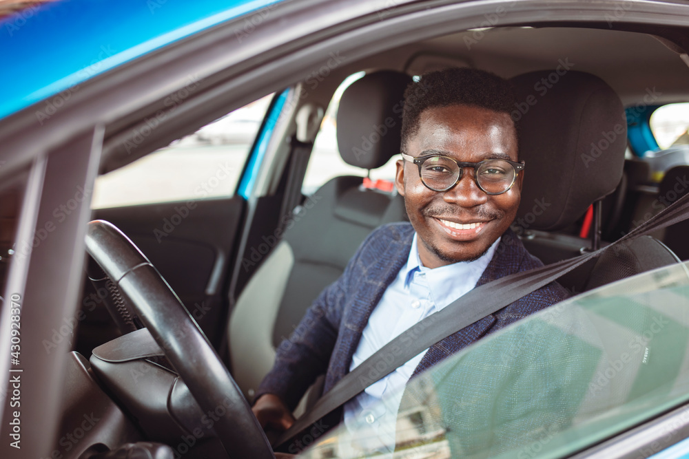 Businessman in his car fastening the seatbelt, safe driving concept. Car safety. Business man fastening seat belt in auto, driving to work, copy space. Man wearing seat belt in car before driving Businessman in his car fastening the seatbelt, safe driving concept. Car safety. Business man fastening seat belt in auto, driving to work, copy space. Man wearing seat belt in car before driving