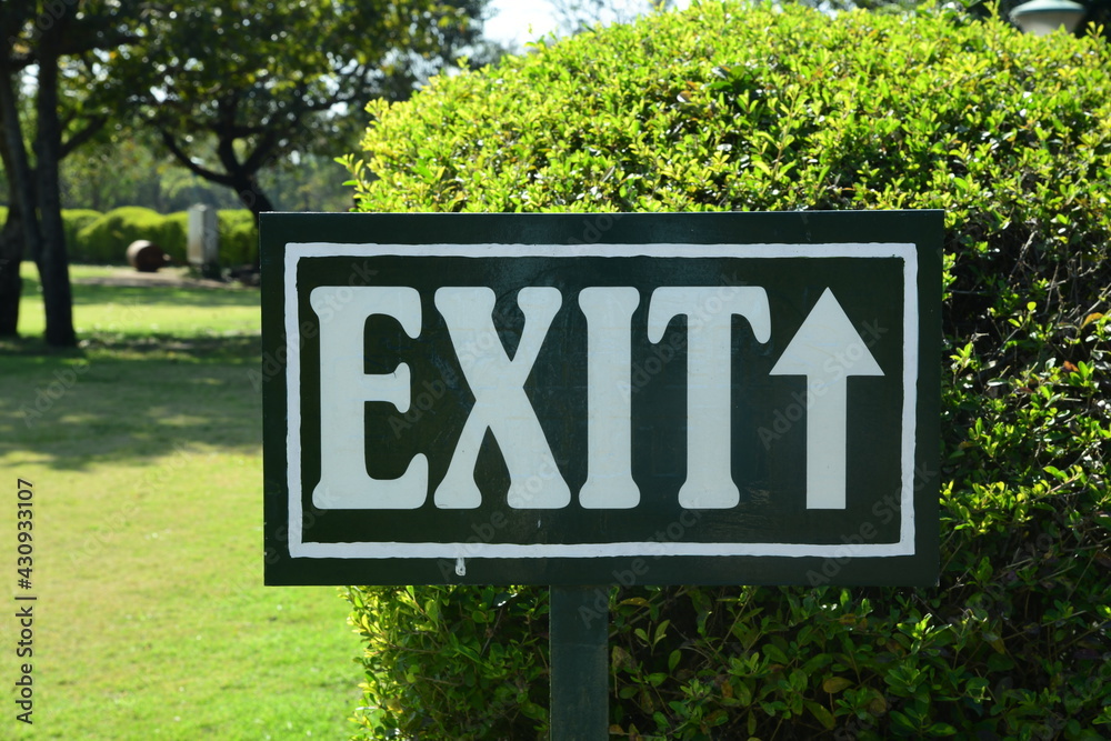 exit sign in garden. Exit board in public space