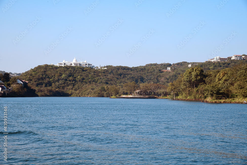 Lake, sea and mountains with temple. Temple in far distance on top of plateau /hill with blue waters /bay Lake, sea and mountains with temple. Temple in far distance on top of plateau /hill with blue waters /bay