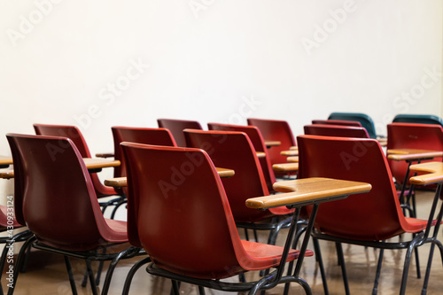 old style Red empty plastic chairs in lecture room