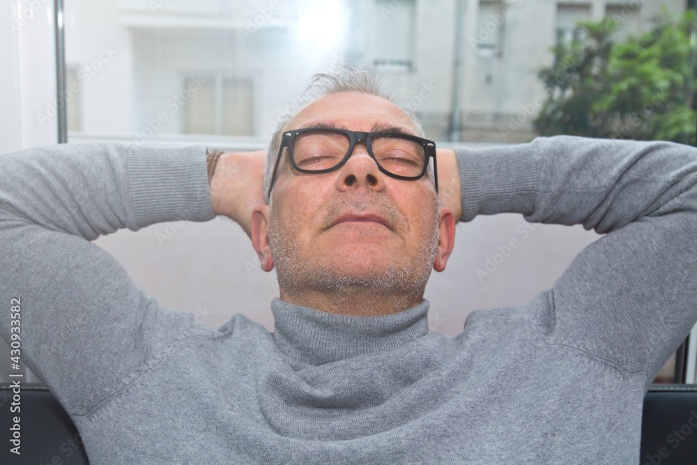 Obraz premium satisfied and relaxed man on the sofa at home