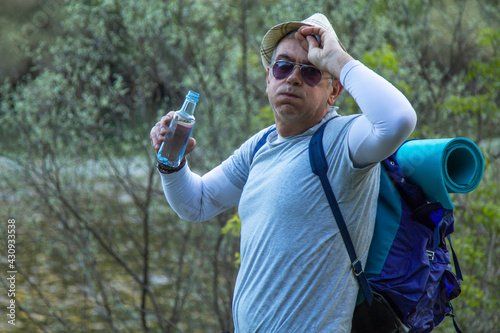 tired hiker or pilgrim stopping to rest and drink