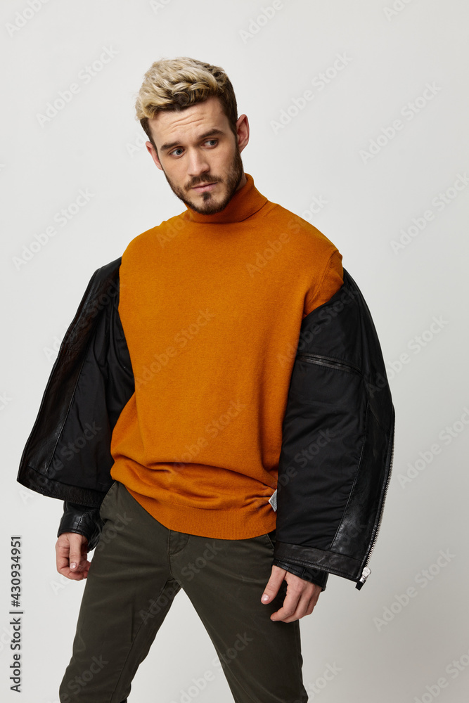 leggings in an orange sweater with an unbuttoned jacket on the shoulders and a light background model leggings in an orange sweater with an unbuttoned jacket on the shoulders and a light background model