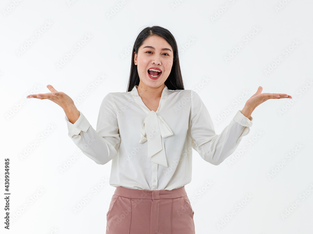 Asian adult business working woman with long black hair wearing white shirt and pink pants, laughing with happiness and raising her hands to present blank copy space on isolated white background. Asian adult business working woman with long black hair wearing white shirt and pink pants, laughing with happiness and raising her hands to present blank copy space on isolated white background.