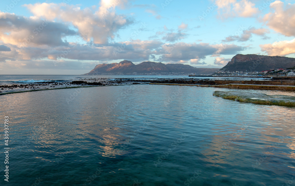 Sunrise reflecting over Dale Brook Tide Pool in Cape Town South Africa RSA