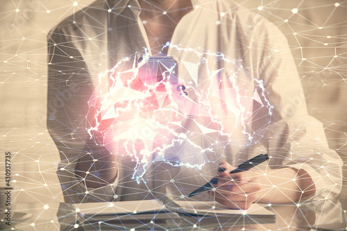 Double exposure of brain sketch hologram and woman holding and using a mobile device.