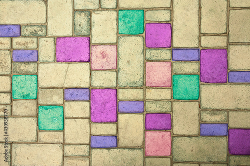 Multi-colored paving slabs are laid in smooth neat rows. Close-up background.
