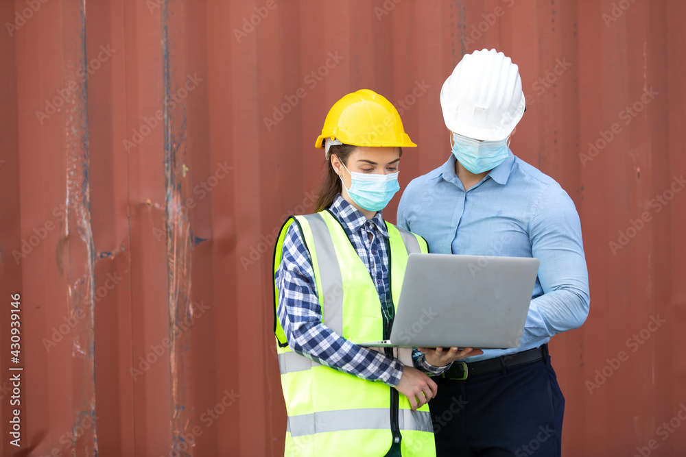 Technical expert in solar photovoltaic panels holding light bulb in hand and discussion with engineer woman in new project. Engineer wearing hygienic mask and protective hard hat. Technical expert in solar photovoltaic panels holding light bulb in hand and discussion with engineer woman in new project. Engineer wearing hygienic mask and protective hard hat.