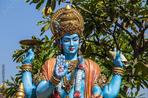 Detail stone statue in indian hindu temple on blue sky background photo
