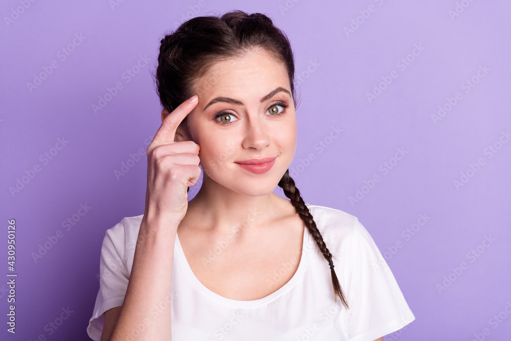 Portrait of friendly satisfied person finger on temple smile look camera isolated on purple color background Portrait of friendly satisfied person finger on temple smile look camera isolated on purple color background