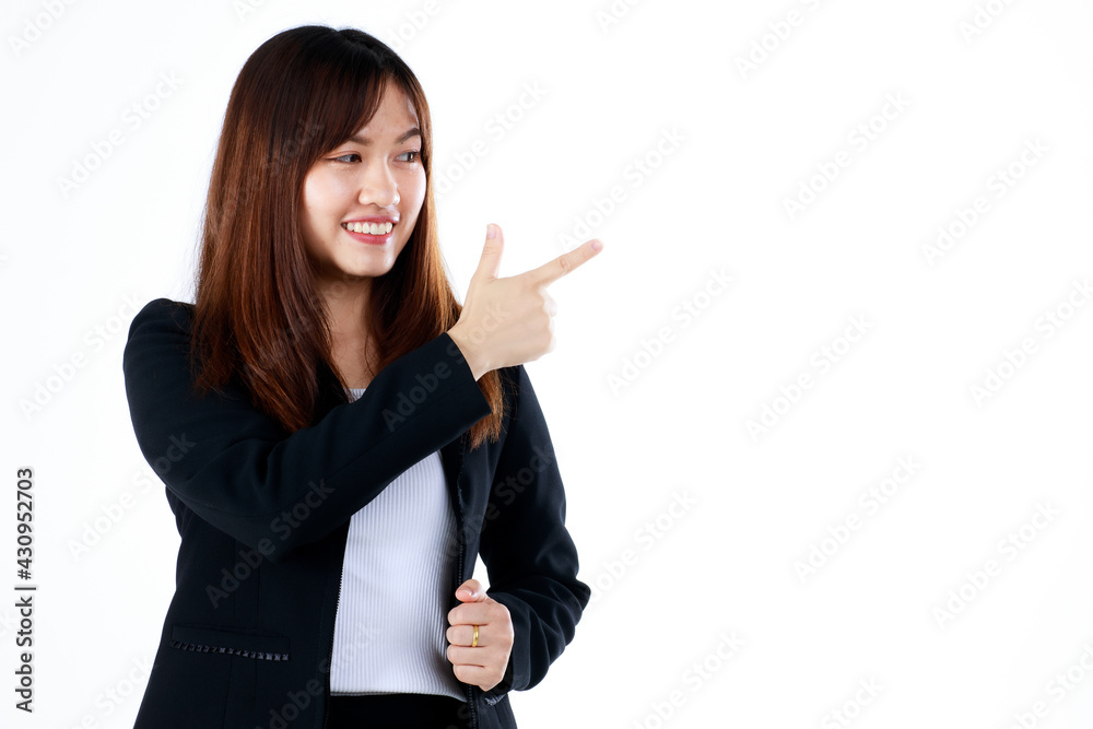 Young and fresh new graduated look Asian businesswoman in suit pose in advertising gesture, pointing finger to blank space for showing or presenting goods and products. Isolated on white background. Young and fresh new graduated look Asian businesswoman in suit pose in advertising gesture, pointing finger to blank space for showing or presenting goods and products. Isolated on white background.