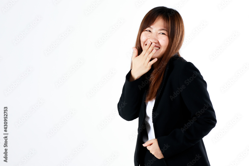 Young and fresh new graduated look Asian businesswoman in suit pose using hand cover mouth while laughing and feel humor on white background Young and fresh new graduated look Asian businesswoman in suit pose using hand cover mouth while laughing and feel humor on white background