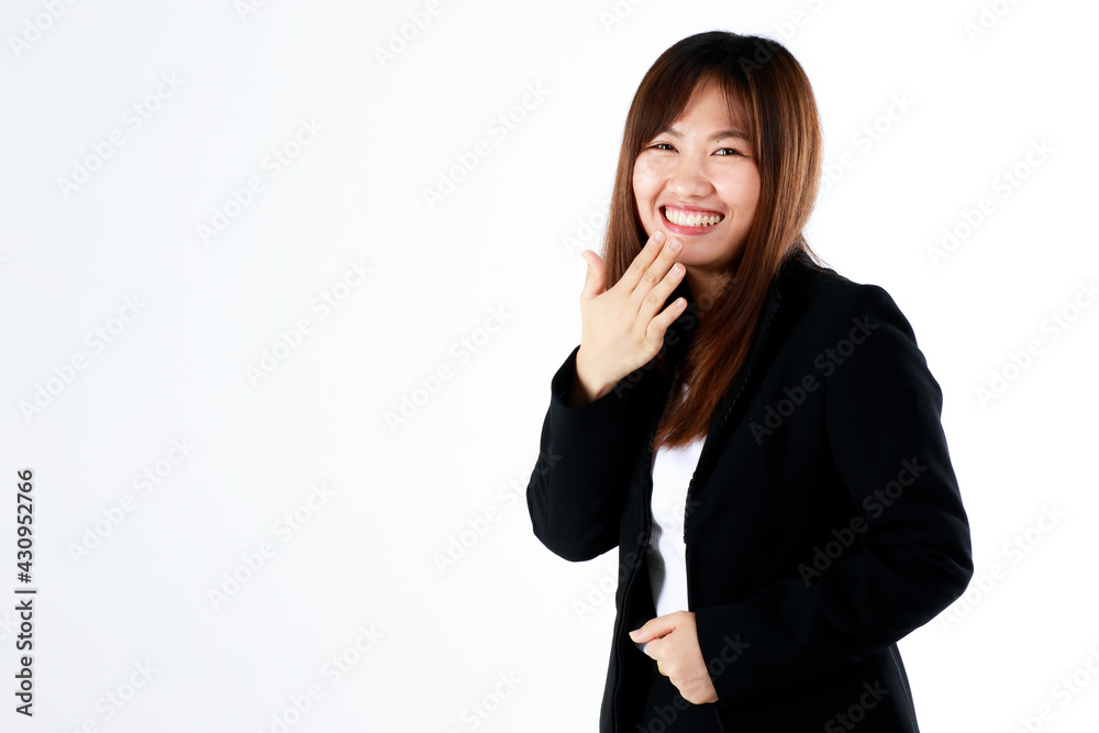 Young and fresh new graduated look Asian businesswoman in suit pose using hand cover mouth while laughing and feel humor on white background Young and fresh new graduated look Asian businesswoman in suit pose using hand cover mouth while laughing and feel humor on white background