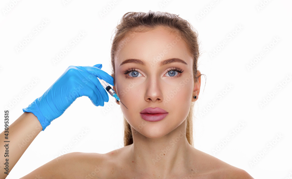 Attractive young woman doing cosmetic injection, isolated over white background.Beauty portrait of brunette with blue eyes. Face care, facial treatment, cosmetic concept beauty and healthy skin.