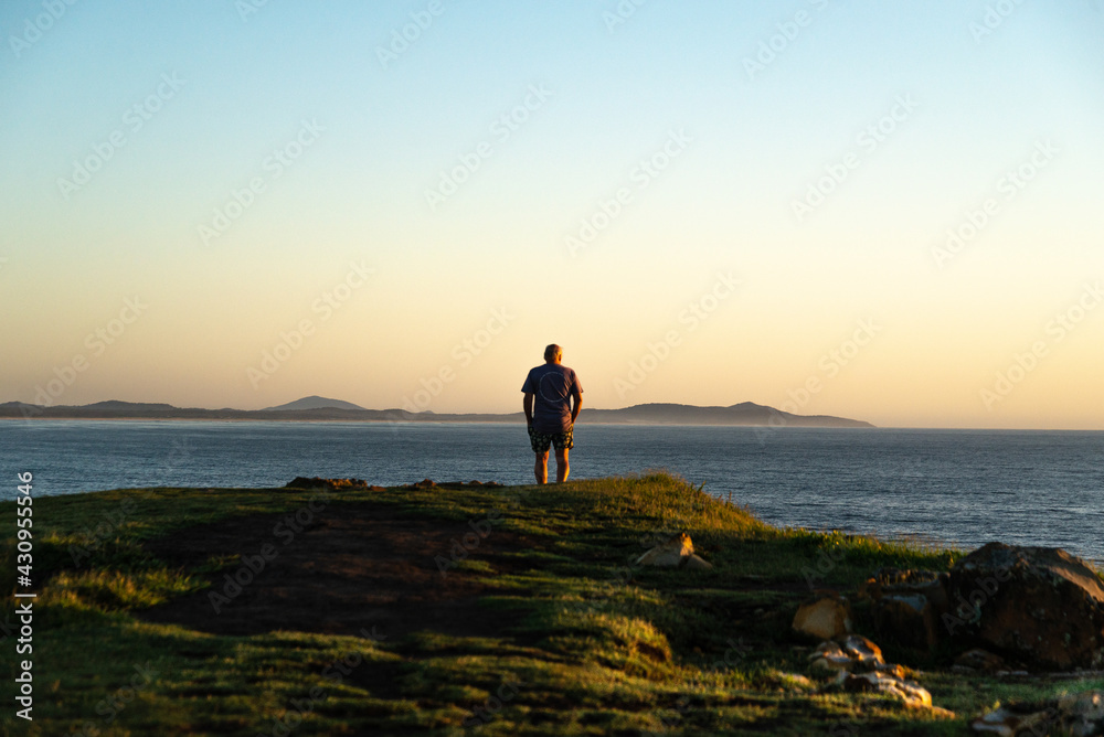 Rear View of Old Man Standing in the Edge of a Hill Looking the Sunrise.Lifestyle and Nature Concept