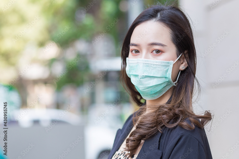 Asian woman who has long hair wears face mask in normal lifestyle to protect COVID-19 or pathogen epidemic in health protection concept. Asian woman who has long hair wears face mask in normal lifestyle to protect COVID-19 or pathogen epidemic in health protection concept.