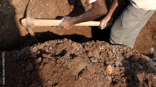 A farmer digs the ground with a shovel in his garden. Close up. The concept of organic farming and ecological vegetable growing photo