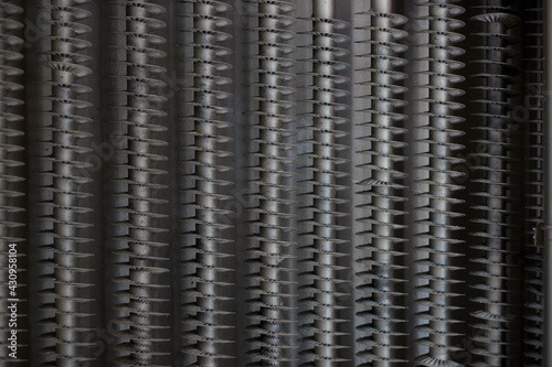 Threaded metal pipes, part of an industrial cooling system, close-up.