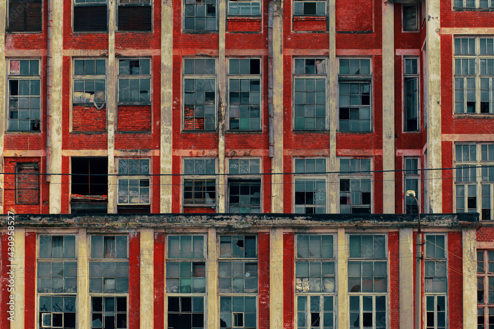 Naklejka premium Close-up of an abandoned factory. Red brick building, broken windows.
