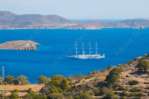 Sailing ship in the bay of Patmos island. Panoramic view. Greece. 