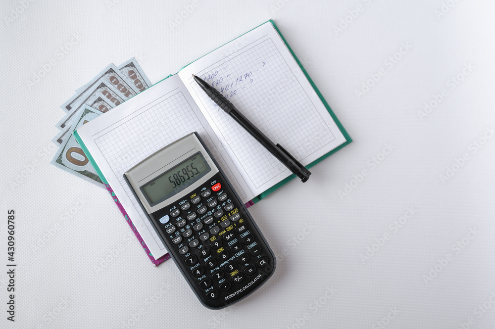 calculator, money, notepad and pen on a white background. Planning and accounting. Home Finance calculator, money, notepad and pen on a white background. Planning and accounting. Home Finance