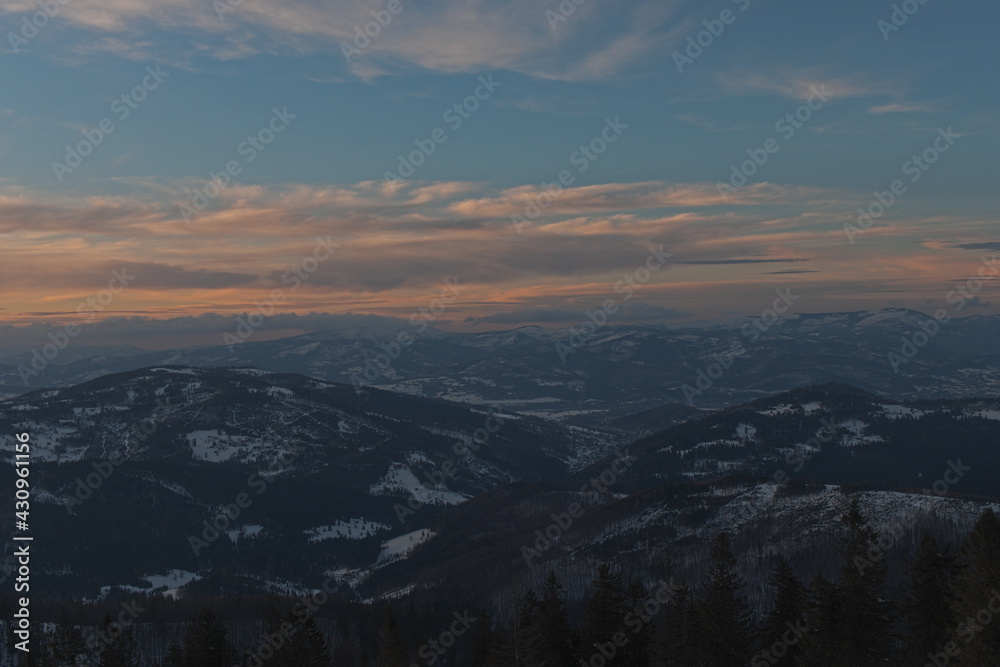 Sunset in the mountains. Colorful sky during the sunset. Winter Beskid Żywiecki.