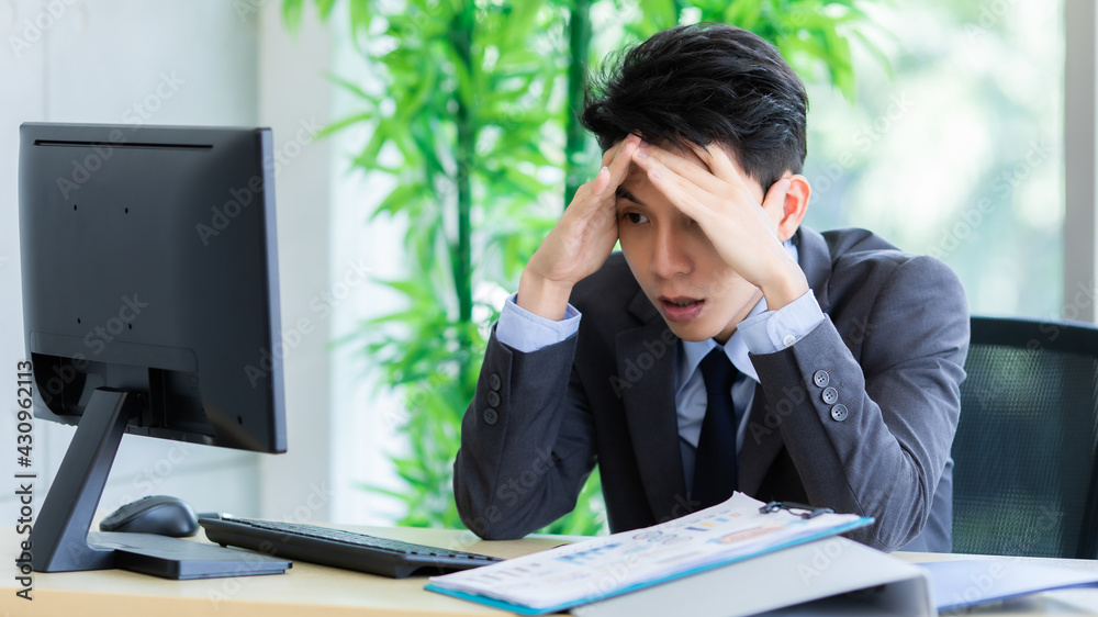 Confused ethnic male entrepreneur working on laptop in office Confused ethnic male entrepreneur working on laptop in office