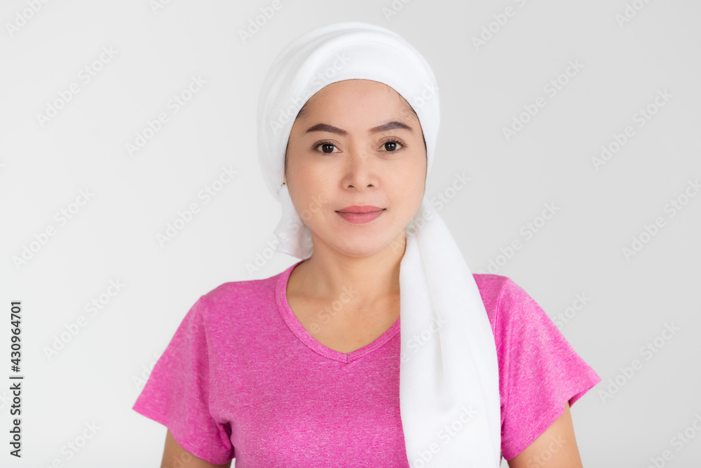 Portrait of a woman cancer patient with clothes covered around head affected from chemotherapy cure process posing with positive and self-confidence Portrait of a woman cancer patient with clothes covered around head affected from chemotherapy cure process posing with positive and self-confidence