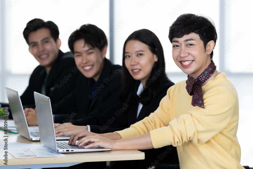 A group of multi-sex colleagues businesspeople, tomboy and transgender gay, working together with happy and intimate manner with laptop notebook computer in office A group of multi-sex colleagues businesspeople, tomboy and transgender gay, working together with happy and intimate manner with laptop notebook computer in office