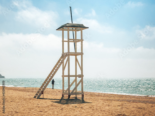 Lifeguard watchtower on the beach, on a sunny day on the coast of the sea.