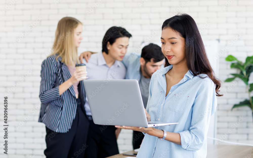 selective focus on Asian businesswomen using a laptop computer to meet with business people Ethnic diversity in the office conference room. Concept meeting diversity cozy. selective focus on Asian businesswomen using a laptop computer to meet with business people Ethnic diversity in the office conference room. Concept meeting diversity cozy.