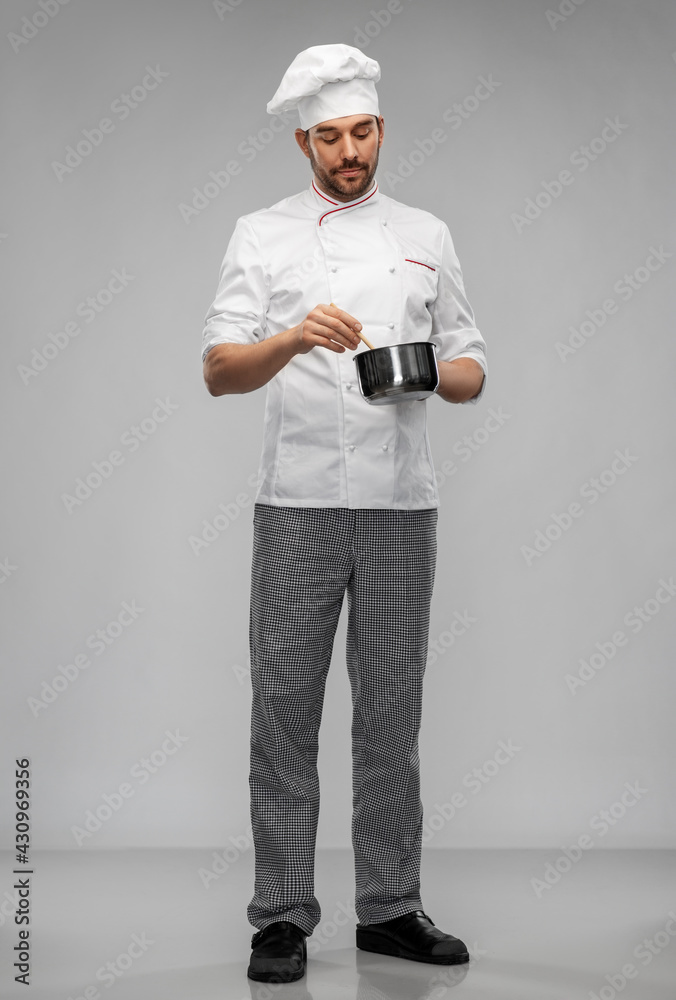 cooking, culinary and people concept - male chef in toque with pot or saucepan over grey background cooking, culinary and people concept - male chef in toque with pot or saucepan over grey background